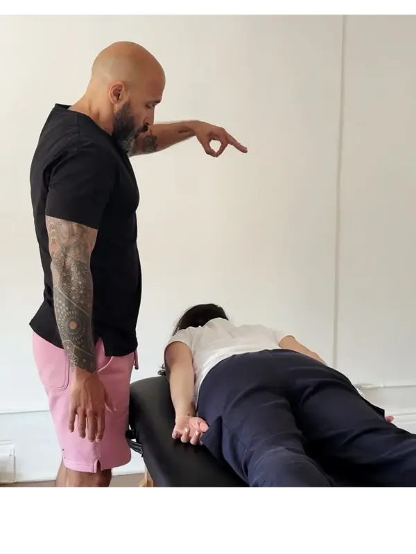 Tommy Ward performing Spinal Energetics, directing energy toward a client in a calm treatment room